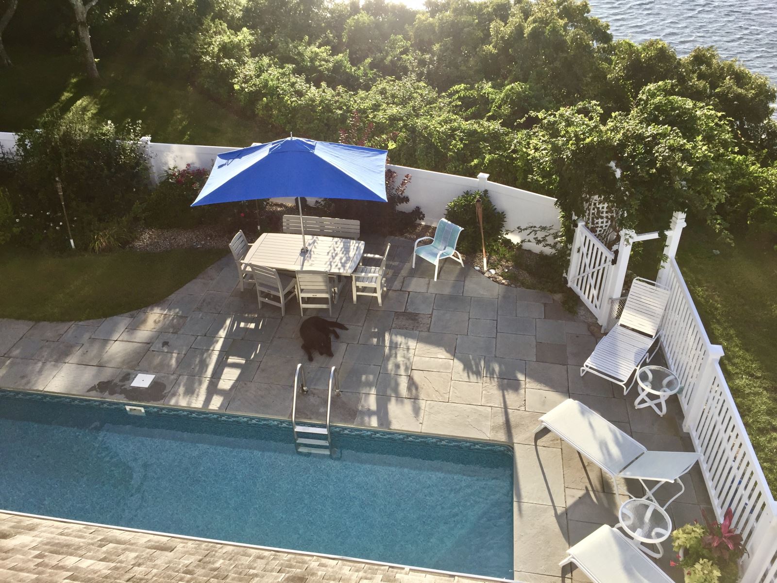 An in-ground pool and patio surrounded by a fence is just one of the safety regulations homeowners will need to abide by when using Nauset Rental as their property manager.