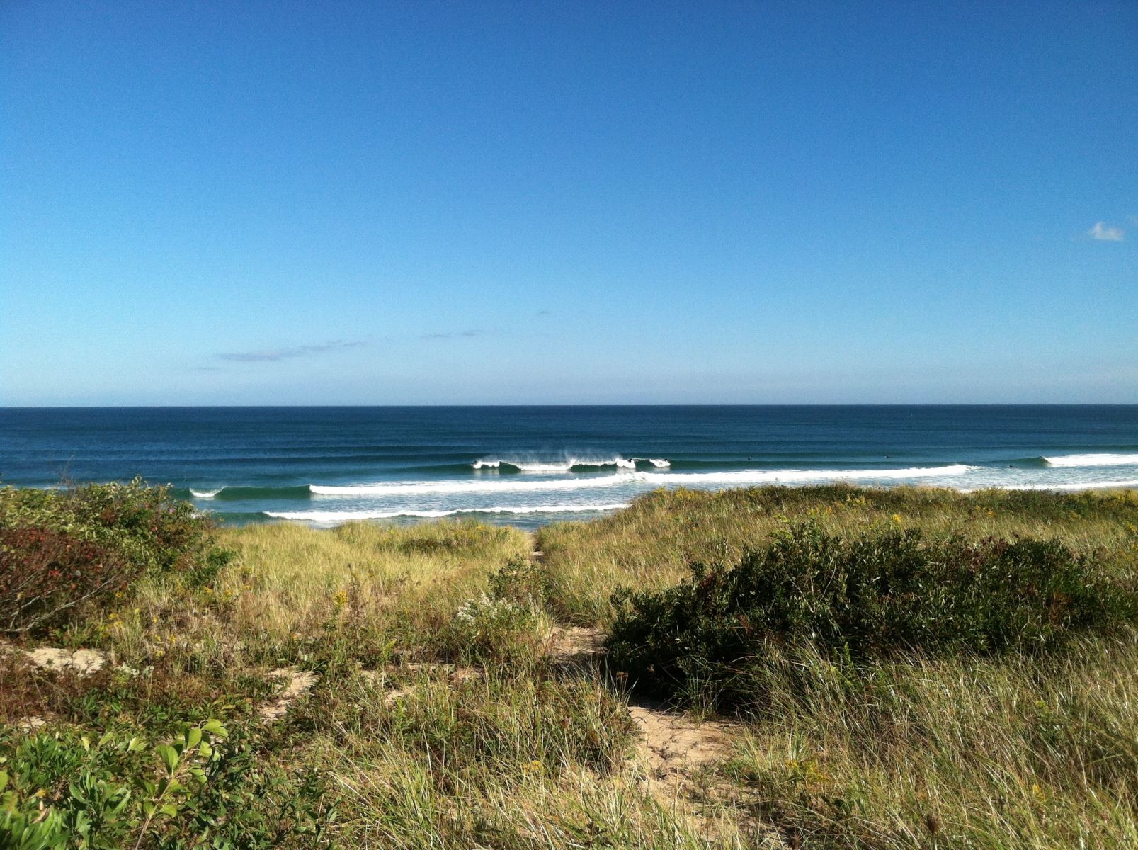 Blue skies, sand dunes and picturesque waves greet you at Coast Guard Beach in Eastham